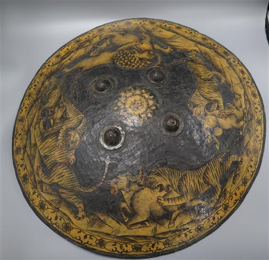 An Indian papier mache shield, depicting hunting tigers and a lion diameter 55cm
